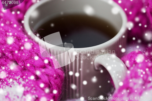 Image of close up of tea or coffee and winter scarf in snow