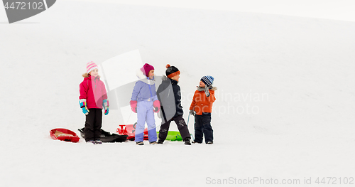 Image of happy little kids with sleds in winter