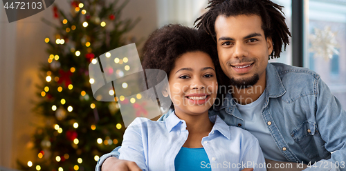 Image of happy couple hugging on christmas