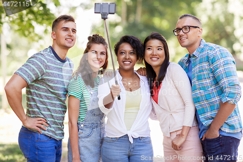 Image of international friends taking selfie in park