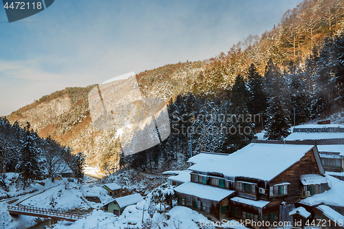 Image of country houses and forest hills in winter, japan