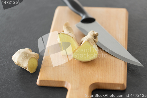 Image of close up of ginger root and knife on cutting board