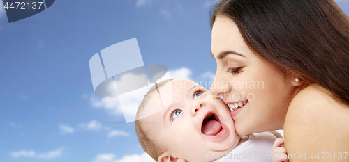Image of mother with baby over sky background