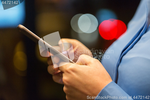 Image of close up of businesswoman hands with smartphone