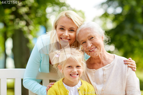 Image of woman with daughter and senior mother at park