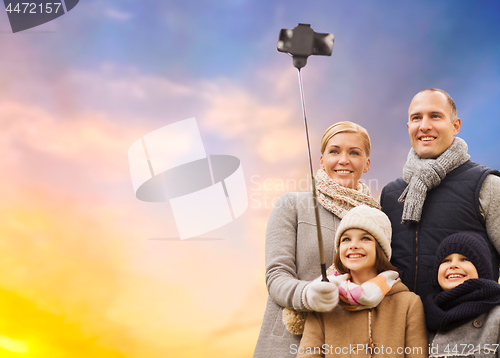 Image of family taking selfie by smartphone outdoors