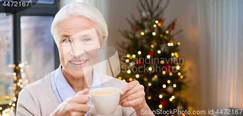 Image of happy senior woman with cup of coffee