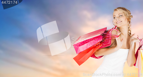 Image of happy woman with shopping bags