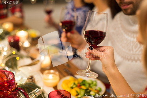 Image of close up of friends drinking red wine on christmas