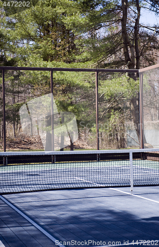 Image of platform tennis paddle court  woods in suburban setting private 