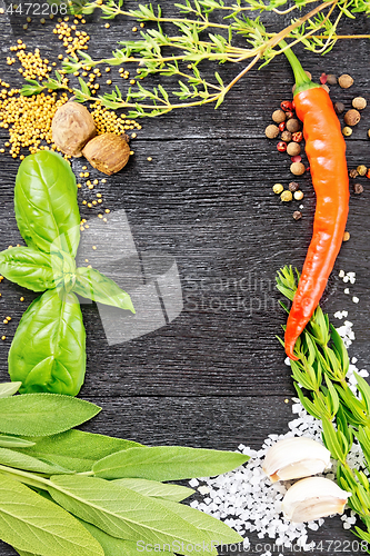 Image of Frame from herbs and pepper on black board