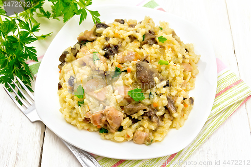 Image of Risotto with mushrooms and chicken on board