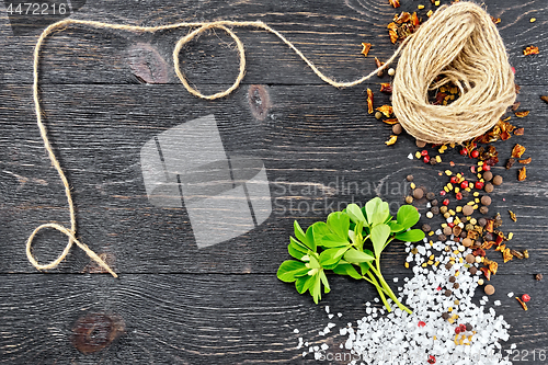 Image of Fenugreek leaves with twine on black board