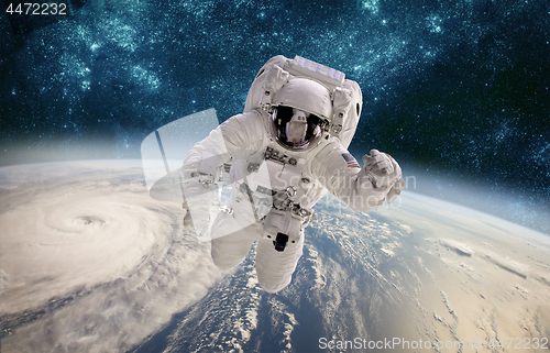 Image of Astronaut in outer space against the backdrop of the planet eart