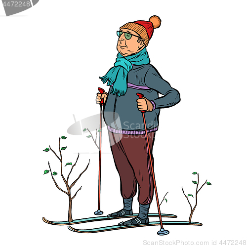 Image of skier male in a forest of young trees