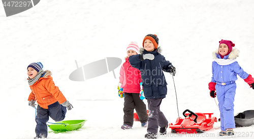 Image of happy little kids with sleds in winter