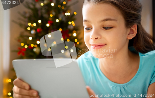 Image of close up of girl with tablet pc on christmas