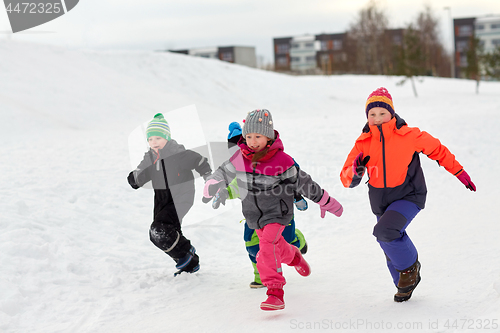 Image of happy little kids running outdoors in winter