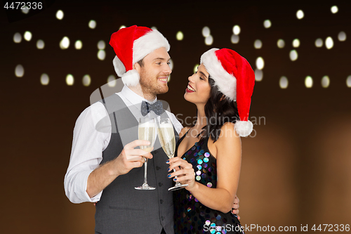 Image of couple with champagne glasses at christmas party