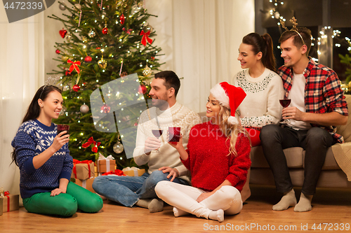 Image of friends celebrating christmas and drinking wine