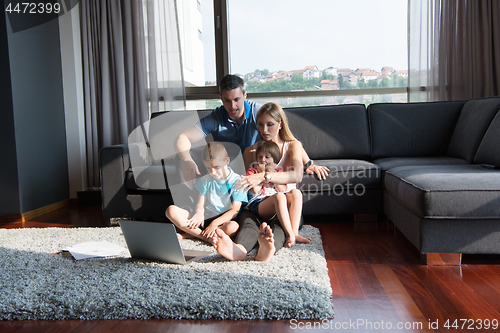 Image of Family Playing Together with laptop computer