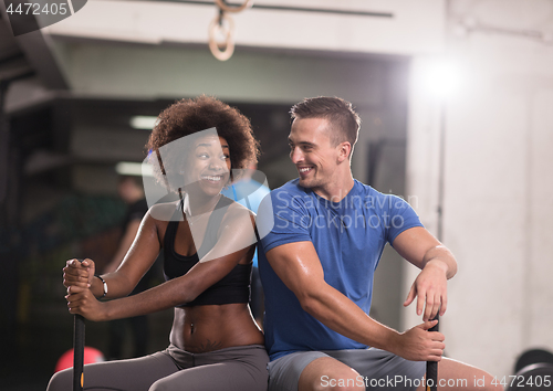 Image of multiethnic couple after workout with hammer