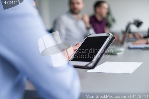 Image of Businessman using tablet in modern office