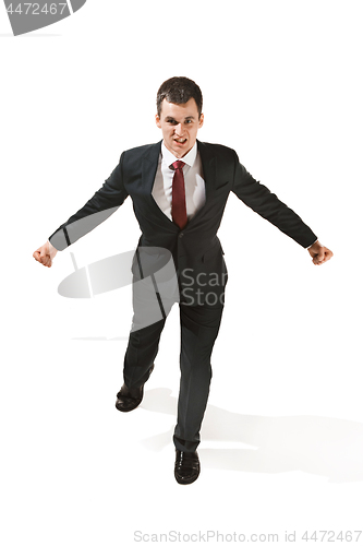 Image of Above front portrait of a businessman with very serious face. Confident professional jumping in the foreground of the camera.