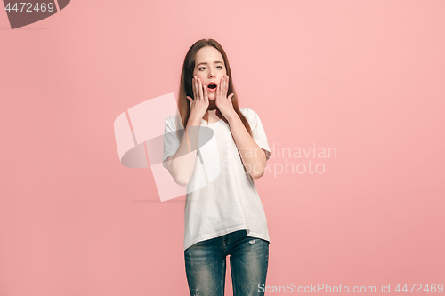 Image of Beautiful teen girl looking suprised isolated on pink