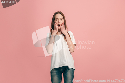 Image of Beautiful teen girl looking suprised isolated on pink