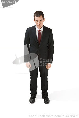 Image of Above front portrait of a businessman with very serious face. Confident professional with piercing look in the foreground of the camera.