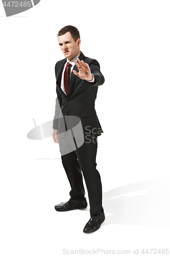 Image of Above front portrait of a businessman with very serious face. Confident professional with piercing look in the foreground of the camera.