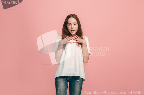 Image of Beautiful teen girl looking suprised isolated on pink