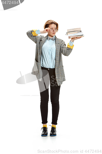 Image of Full length portrait of a sad female student holding books isolated on white background