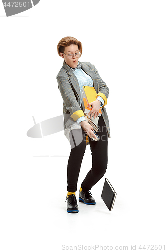 Image of Full length portrait of a unhappy female student holding books isolated on white background