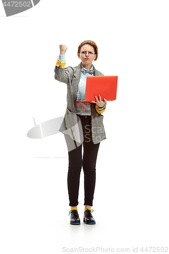 Image of Full length portrait of a angry female student holding notebook isolated on white background