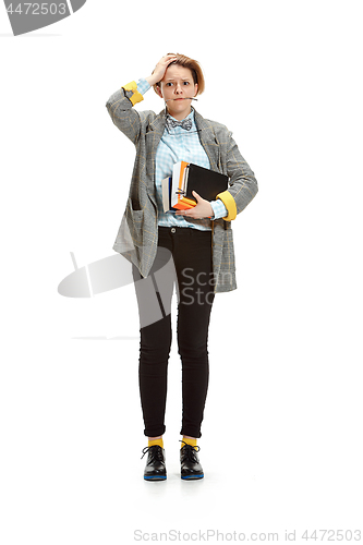 Image of Full length portrait of a sad female student holding books isolated on white background