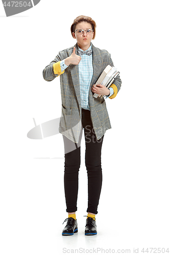 Image of Full length portrait of a surprised female student holding books isolated on white background