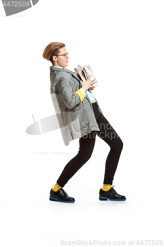 Image of Full length portrait of a unhappy female student holding books isolated on white background