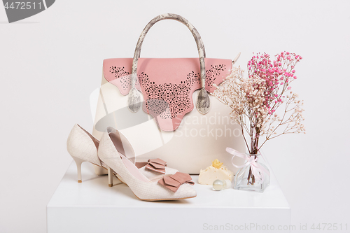 Image of Female handbag, shoes and bouquet of dried flowers