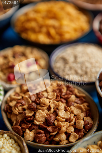 Image of Assortment of different kinds cereals placed in ceramic bowls on table