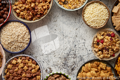 Image of Assortment of different kinds cereals placed in ceramic bowls on table