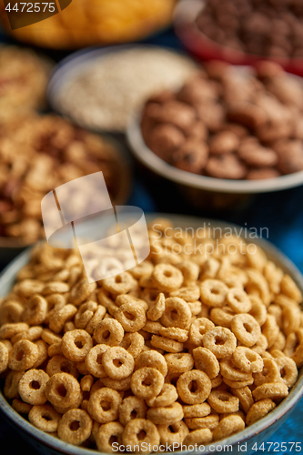 Image of Assortment of different kinds cereals placed in ceramic bowls on table