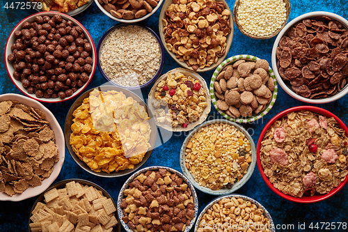 Image of Assortment of different kinds cereals placed in ceramic bowls on table