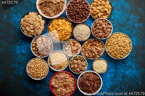 Image of Assortment of different kinds cereals placed in ceramic bowls on