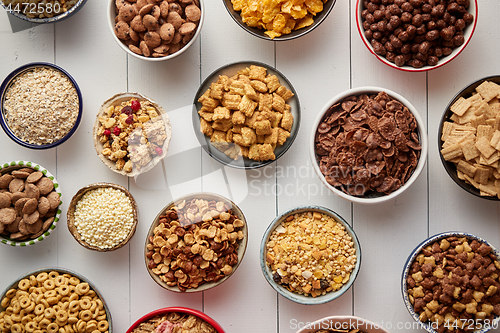 Image of Assortment of different kinds cereals placed in ceramic bowls on table