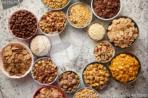 Image of Assortment of different kinds cereals placed in ceramic bowls on table