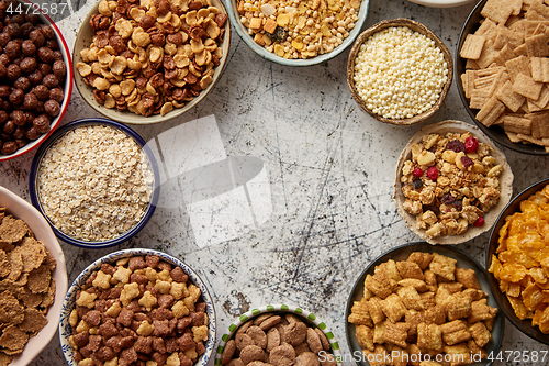 Image of Assortment of different kinds cereals placed in ceramic bowls on table