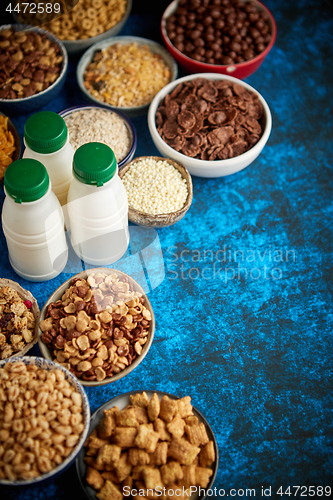 Image of Assortment of different kinds cereals placed in ceramic bowls on table