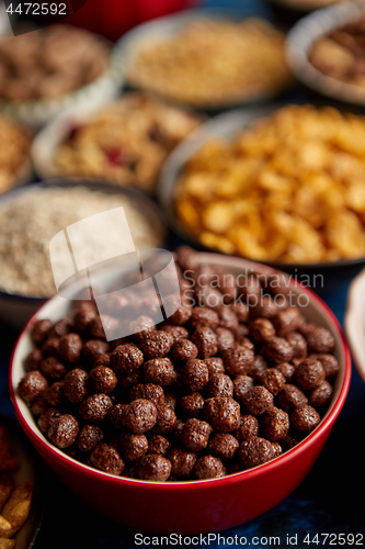 Image of Assortment of different kinds cereals placed in ceramic bowls on table